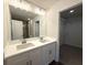 Double vanity bathroom featuring modern fixtures and a large mirror at 5455 Blossomwood Sw Trl, Mableton, GA 30126