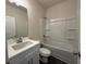 A well-lit bathroom with a combination shower-tub at 5455 Blossomwood Sw Trl, Mableton, GA 30126
