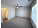 Bright bedroom features a ceiling fan, plush carpeting and a view into the ensuite bathroom at 5455 Blossomwood Sw Trl, Mableton, GA 30126