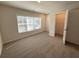 Bright bedroom featuring a large window, neutral carpet and an open closet at 5455 Blossomwood Sw Trl, Mableton, GA 30126