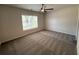 Bright bedroom with a ceiling fan and natural light streaming through a large window at 5455 Blossomwood Sw Trl, Mableton, GA 30126