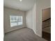 A carpeted room featuring a window with natural light at 5455 Blossomwood Sw Trl, Mableton, GA 30126