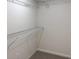 A walk-in closet with carpet, wire shelving, and an electrical outlet at 5455 Blossomwood Sw Trl, Mableton, GA 30126