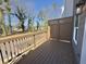 View of a private outdoor deck with brown wood railing, gray siding, and trees at 5455 Blossomwood Sw Trl, Mableton, GA 30126