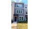 Charming townhouse with a gray facade, manicured lawn, and neatly arranged landscaping at 5455 Blossomwood Sw Trl, Mableton, GA 30126