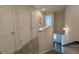 Well-lit hallway with a large closet and views of windows at the end of the hall at 5455 Blossomwood Sw Trl, Mableton, GA 30126