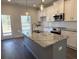 A view of the kitchen, showcasing the large island and white cabinets at 5455 Blossomwood Sw Trl, Mableton, GA 30126