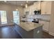 Kitchen island with granite countertops, stainless steel sink, and pendant lighting at 5455 Blossomwood Sw Trl, Mableton, GA 30126