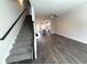Open-concept living space with stairs, connecting living room to kitchen at 5455 Blossomwood Sw Trl, Mableton, GA 30126