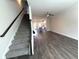 Spacious living room with hardwood floors, stairs, and an open concept layout flowing into the kitchen at 5455 Blossomwood Sw Trl, Mableton, GA 30126