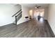 Spacious living room featuring stairs, hardwood floors, and an electric fireplace at 5455 Blossomwood Sw Trl, Mableton, GA 30126