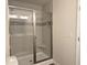 Modern shower with glass doors, tiled walls, and a built-in seat, showcasing contemporary design at 5455 Blossomwood Sw Trl, Mableton, GA 30126