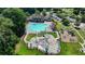 Aerial shot showcases a sparkling community pool, splash pad, playground, and manicured green spaces at 3743 Heathermoor Ct, Dacula, GA 30019