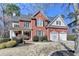 Stately brick home showcases lush landscaping and a welcoming two-car garage at 3743 Heathermoor Ct, Dacula, GA 30019