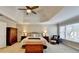 Main bedroom featuring a tray ceiling, large window, and neutral color palette at 3743 Heathermoor Ct, Dacula, GA 30019