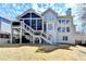 Rear exterior view featuring a screened-in porch, a walk-out deck, and a well-maintained lawn at 3743 Heathermoor Ct, Dacula, GA 30019