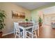 Dining area featuring a table for four, hardwood floors, natural light, and adjacent to the kitchen at 4645 Valais Ct # 162, Alpharetta, GA 30022