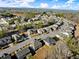 An aerial view of a serene neighborhood with neatly lined houses and beautiful landscaping under a blue sky at 485 St Annes Pl, Covington, GA 30016