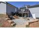 Inviting backyard features a stone firepit area, wooden deck, and a partially walk-out basement at 8321 Banks Mill Rd, Douglasville, GA 30135