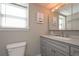 Bathroom with large grey vanity, modern sink, and neutral wall art at 8321 Banks Mill Rd, Douglasville, GA 30135