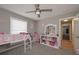Secondary bedroom with loft bed, fan, and large window providing natural light at 8321 Banks Mill Rd, Douglasville, GA 30135