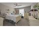 Neutral bedroom featuring a ceiling fan, window and beige furniture at 8321 Banks Mill Rd, Douglasville, GA 30135