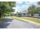 Well-maintained home with stone chimney, lush lawn, an outbuilding, and convenient paved driveway at 8321 Banks Mill Rd, Douglasville, GA 30135