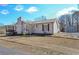 Cozy home with a stone chimney, well-maintained lawn, and an outbuilding for extra storage or a workshop at 8321 Banks Mill Rd, Douglasville, GA 30135
