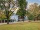 Charming two-story home with mature trees and a spacious front yard at 8321 Banks Mill Rd, Douglasville, GA 30135