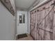 Hallway with wood-look barn door and coat hooks with access to the exterior at 8321 Banks Mill Rd, Douglasville, GA 30135