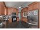 Kitchen with stainless steel appliances, wood cabinets, and dark granite countertops at 8321 Banks Mill Rd, Douglasville, GA 30135