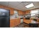Traditional kitchen with appliances, oak cabinets, and eat-in dining area at 8321 Banks Mill Rd, Douglasville, GA 30135