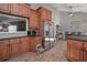 Bright eat-in kitchen featuring tile floors, stainless steel appliances, and wood cabinets at 8321 Banks Mill Rd, Douglasville, GA 30135