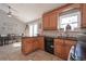 Bright eat-in kitchen featuring tile floors, black appliances, and wood cabinets at 8321 Banks Mill Rd, Douglasville, GA 30135
