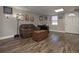 Living room features wood floors, a brown leather couch, and wall decor at 8321 Banks Mill Road Rd, Douglasville, GA 30135