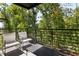 Outdoor patio with metal railing and two white lounge chairs at 1290 Lupo Loop, Chattahoochee Hills, GA 30268