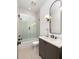 Bathroom with a vanity sink and glass door shower/tub combo at 1290 Lupo Loop, Chattahoochee Hills, GA 30268
