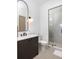 Contemporary bathroom with a gray vanity, black hardware and glass shower at 1290 Lupo Loop, Chattahoochee Hills, GA 30268