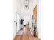 Bright entryway featuring hardwood floors, coat rack, and modern light fixture at 1290 Lupo Loop, Chattahoochee Hills, GA 30268