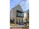 Modern home with a striking balcony, outdoor seating, and a well-maintained backyard at 1290 Lupo Loop, Chattahoochee Hills, GA 30268