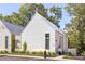 Modern white home with a striking roofline and well-manicured landscaping at 1290 Lupo Loop, Chattahoochee Hills, GA 30268