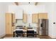 Modern kitchen with stainless steel appliances, light wood cabinetry, and eat-in island at 1290 Lupo Loop, Chattahoochee Hills, GA 30268