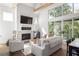 Bright living room featuring a fireplace, high ceilings, and abundant natural light at 1290 Lupo Loop, Chattahoochee Hills, GA 30268