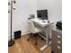 Modern office space with an adjustable desk and hardwood floors at 1290 Lupo Loop, Chattahoochee Hills, GA 30268
