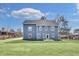 Spacious backyard view features a well-manicured lawn, recently planted landscaping, and blue home exterior at 474 Maxwell Rd, Roswell, GA 30075