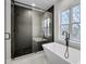 A bathroom featuring a modern soaking tub, glass shower, and a window at 474 Maxwell Rd, Roswell, GA 30075