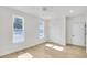 Bright bedroom with hardwood floors, a ceiling fan, and two windows at 474 Maxwell Rd, Roswell, GA 30075