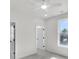 Bedroom features plush carpeting, ceiling fan, and a sunny window at 474 Maxwell Rd, Roswell, GA 30075