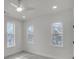 A bright bedroom features three windows and recessed lighting at 474 Maxwell Rd, Roswell, GA 30075
