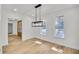 Dining room with modern light fixture, neutral paint, and views from two windows at 474 Maxwell Rd, Roswell, GA 30075